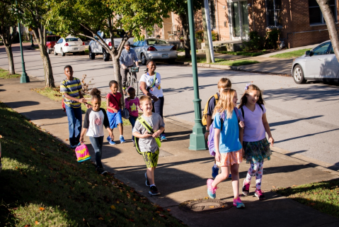 children walking to school on sidewalk